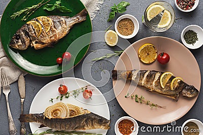 Whole grilled dorado and sea bass on table Stock Photo