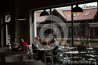 Breakfast at the restaurant. Girls are sitting at a table in a restaurant. Editorial Stock Photo