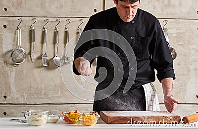 Restaurant hotel private chef dusting flour on board Stock Photo