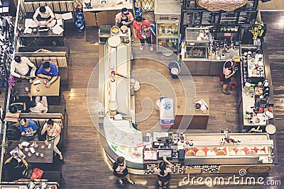 Restaurant with kitchen and people sitting at tables seen from above Editorial Stock Photo