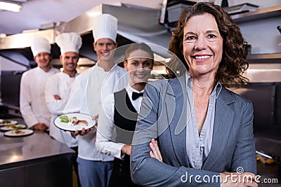 Restaurant manager posing in front of team of staff Stock Photo