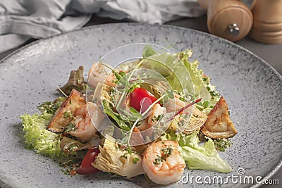 Restaurant menu. Warm salad with tomatoes, king prawns, eggplant and lettuce. Stock Photo