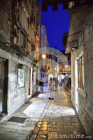 Restaurant in narrow streets of mediterranean city. Trogir at night. Croatia Editorial Stock Photo