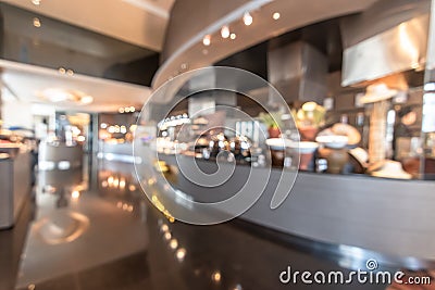Restaurant open kitchen blur background in luxury hotel showing chef cooking over blurry food counter for buffet catering service Stock Photo