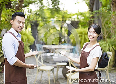 Restaurant owner with welcome gesture Stock Photo