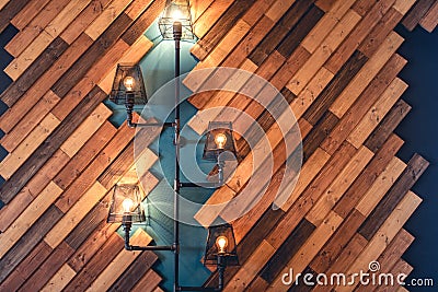 Restaurant with rustic decorative elements. Interior design details with lamps and bulb lights. Wooden wall decoration Stock Photo