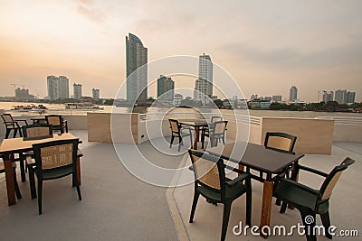 Restaurant seats and tables near the river, restaurant interior. Stock Photo