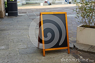 Restaurant sidewalk chalkboard sign board. Old Black Signboard on the street. Blank store signage sign design mockup Stock Photo