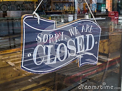 A restaurant `Sorry, we`re closed` glass door sign. Editorial Stock Photo