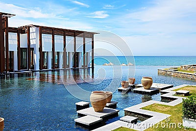 The restaurant and swimming pool near beach at luxury hotel Stock Photo