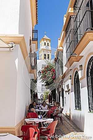 Restaurant tables in narrow alley Marbella old town Editorial Stock Photo