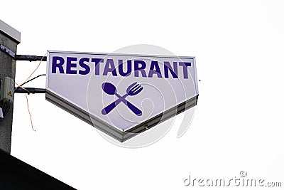 Restaurant text sign on mast panel board facade building city street storefront Stock Photo