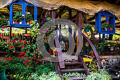 Restaurant in a vintage yard with wooden house, beautiful garden and much retro details Editorial Stock Photo