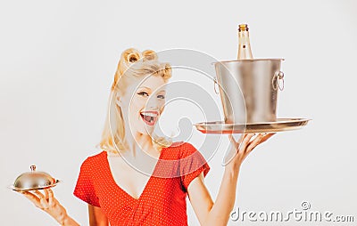 Restaurant waiter with champagne. Pinup girl with service tray. Serving presentation concept. Stock Photo