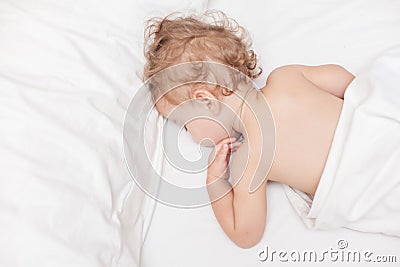 Restful two years old baby girl sleeping on bed Stock Photo