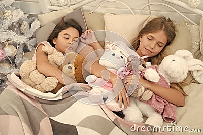 Resting on winter holidays. Sleeping children. Little children sleep at Christmas tree. Little girls lying in bed with Stock Photo