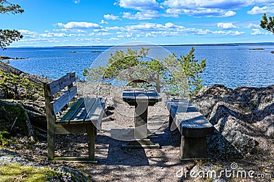restingplace with two benches and a table overlooking lake Vattern Motala Sweden april 30 2022 Stock Photo