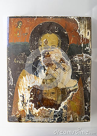 Restoration of the face of an ancient icon from under the layer on which a later icon is painted Editorial Stock Photo