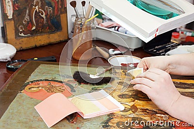 Restoration and gilding the ancient icon Stock Photo