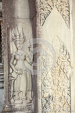 Restored Apsara relief at the entrance of Ta Prohm temple, Angkor Thom, Siem Reap, Cambodia. Stock Photo