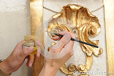 Restorer manually gilding listed interior Stock Photo