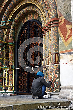 A restorer at work, Dormition church facade of Moscow Kremlin. UNESCO World Heritage Site. Editorial Stock Photo