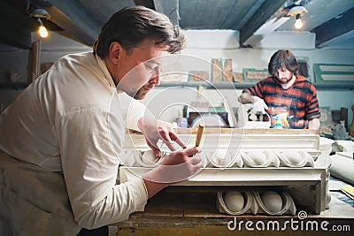 Restorers working with gypsum models Stock Photo