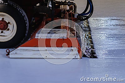 Resurfacer machine levels ice at stadium. Winter Hockey Stock Photo