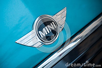 Retail of Austin mini cooper logo on blue car parked in the street Editorial Stock Photo