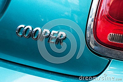 Retail of Austin mini cooper logo on blue car parked in the street Editorial Stock Photo