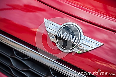 Retail of Austin mini cooper logo on red car parked in the street Editorial Stock Photo