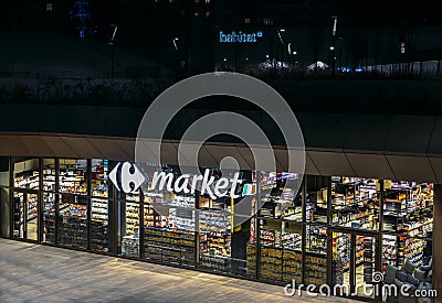 Retail giant, Carrefour supermaket, closed at night in the CityLife district of Milan, Lombardy, Italy Editorial Stock Photo