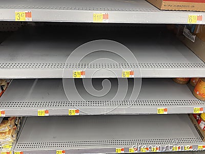 Retail store Jif peanut butter recall looking down empty shelves Editorial Stock Photo