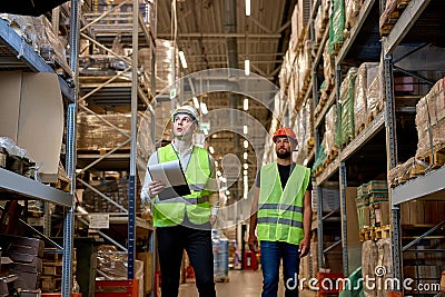 Retail Warehouse full of Shelves with Goods, Young Workers Supervisors Discuss Product Delivery Stock Photo