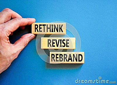 Rethink revise rebrand symbol. Concept word Rethink Revise Rebrand on beautiful block. Beautiful blue table blue background. Stock Photo