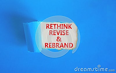 Rethink revise rebrand symbol. Concept word Rethink Revise and Rebrand on beautiful white paper. Beautiful blue paper background. Stock Photo