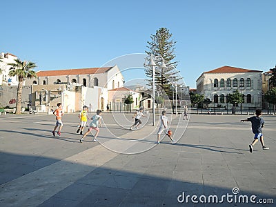 Rethymno, Greece - june 15, 2017: boys teenagers of different nationalities playing football on a Sunny evening in the city center Editorial Stock Photo