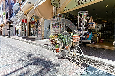 Rethymnon, Island Crete, Greece, - July 1, 2016: The tourist shop on the street of the old town of Rethymnon and the bicycle with Editorial Stock Photo