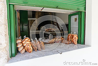 Rethymnon, Island Crete, Greece, - July 1, 2016: Window of bakery with fresh and tasty muffins, pastry and bread on the street Editorial Stock Photo