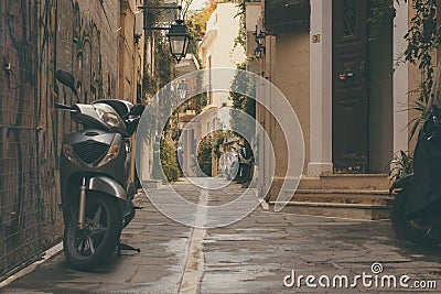 Rethymnon, Island Crete, Greece, - June 08, 2017: old parked scooter and a vintage front door of the old town's part of city Reth Editorial Stock Photo