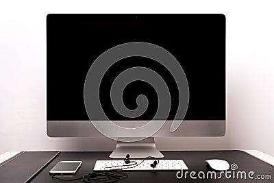 Retina display with keyboard, mouse, smart phone and earphone Stock Photo