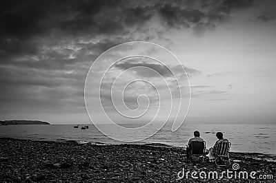 Retired Couple On Relaxing Sunset Shore Editorial Stock Photo