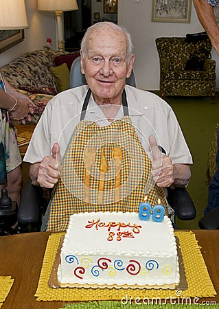 Retired family physician celebrating his 88th birthday in his home with his family. Stock Photo