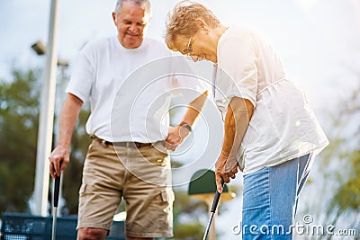 Retired lifestyle of senior couple playing mini golf Stock Photo