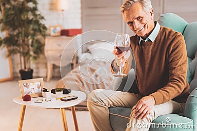 Retired man drinking wine celebrating his birthday Stock Photo