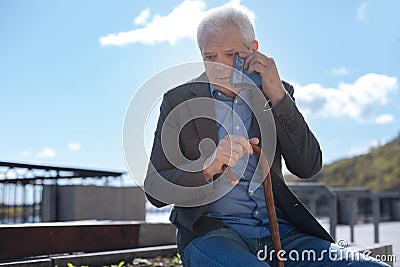 Retired man feeling depressed in the park Stock Photo