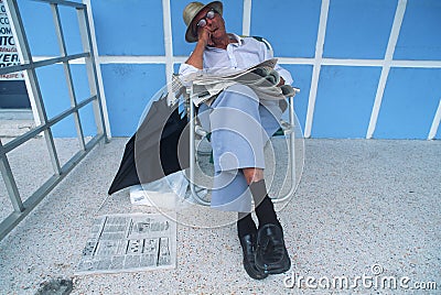 Retired man sleeping in chair Editorial Stock Photo