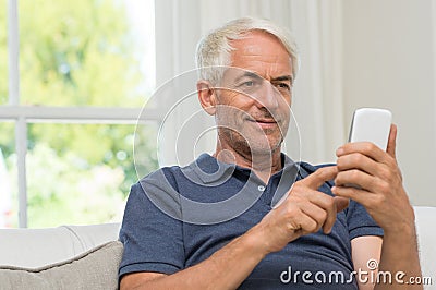 Retired man texting Stock Photo