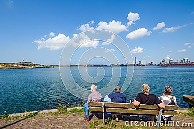 Retired people look across the water on the North Sea coast to m Editorial Stock Photo