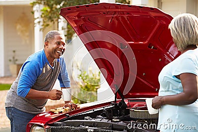 Retired Senior Couple Working On Restored Car Stock Photo